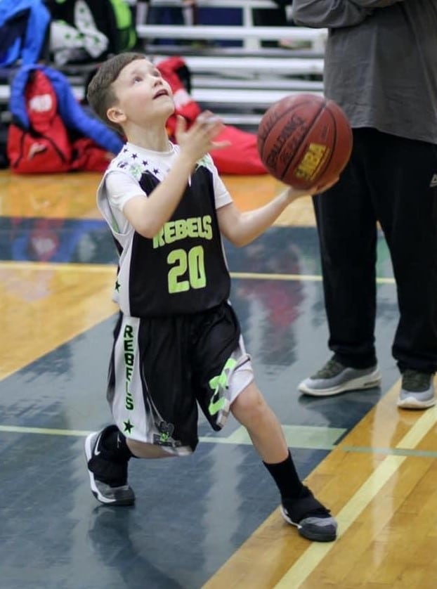Boy taking the shot at basketball